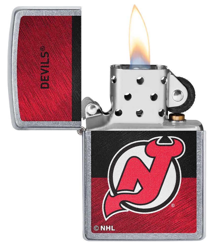 NHL® New Jersey Devils Street Chrome™ Windproof Lighter with its lid open and lit