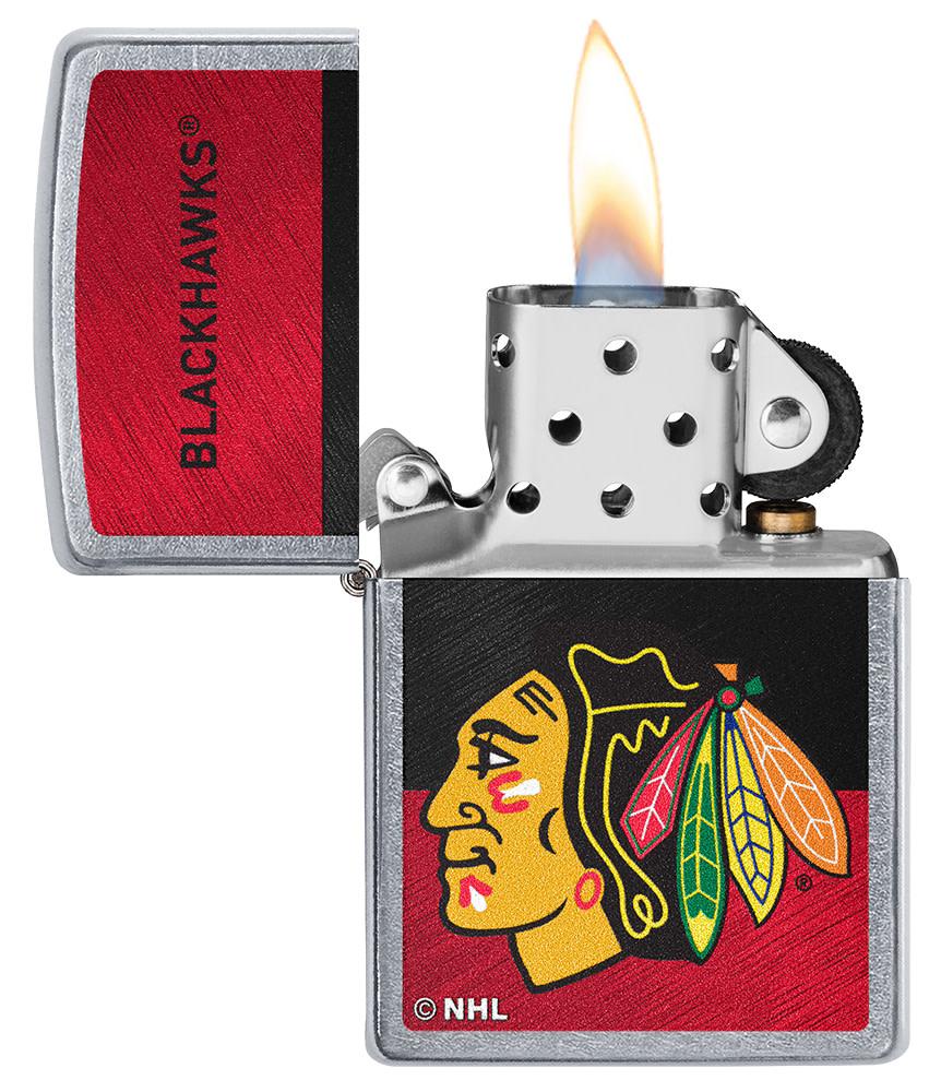 NHL® Chicago Blackhawks Street Chrome™ Windproof Lighter with its lid open and lit