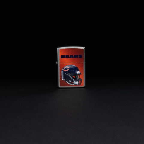 Lifestyle image of NFL Chicago Bears Helmet Street Chrome Windproof Lighter standing in a black background.