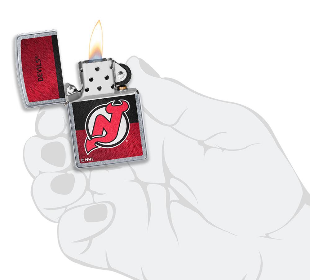 NHL® New Jersey Devils Street Chrome™ Windproof Lighter lit in hand