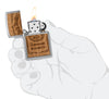 Zippo Jack Daniel's Woodchuck USA Brushed Chrome Windproof Lighter lit in hand.