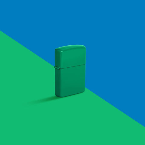 Glamour shot of Zippo Grass Green Matte Classic Windproof Lighter standing in a split blue and green scene.