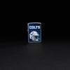 Lifestyle image of NFL Indianapolis Colts Helmet Street Chrome Windproof Lighter standing in a black background.