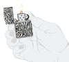 Zebra Print Design 540 Color Windproof Lighter lit in hand.
