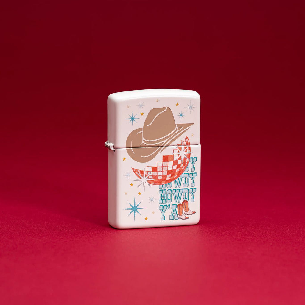 Lifestyle image of Zippo Howdy Cowboy White Matte Windproof Lighter standing in a red scene.
