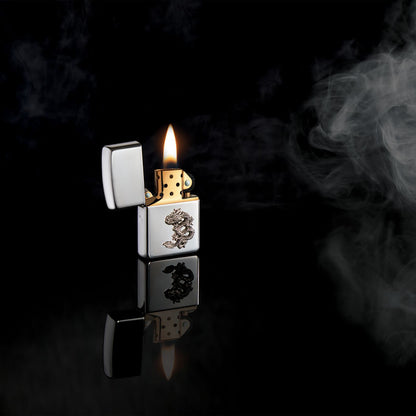 Lifestyle image of ArmorÂ® Chinese Dragon Sterling Silver Emblem Windproof Lighter open and lit standing in a black scene with smoke.