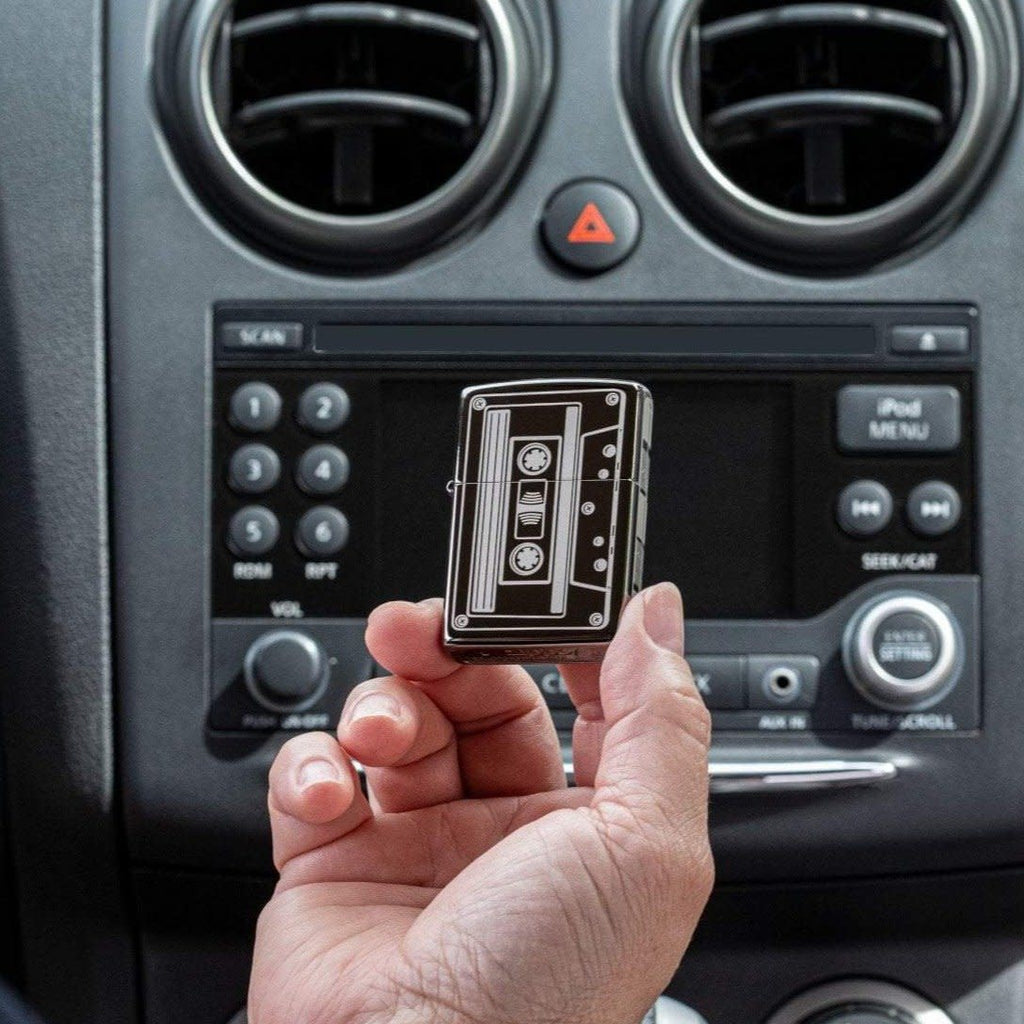 Lifestyle shot of Cassette Tape Black Ice® Windproof Lighter in a car in hand