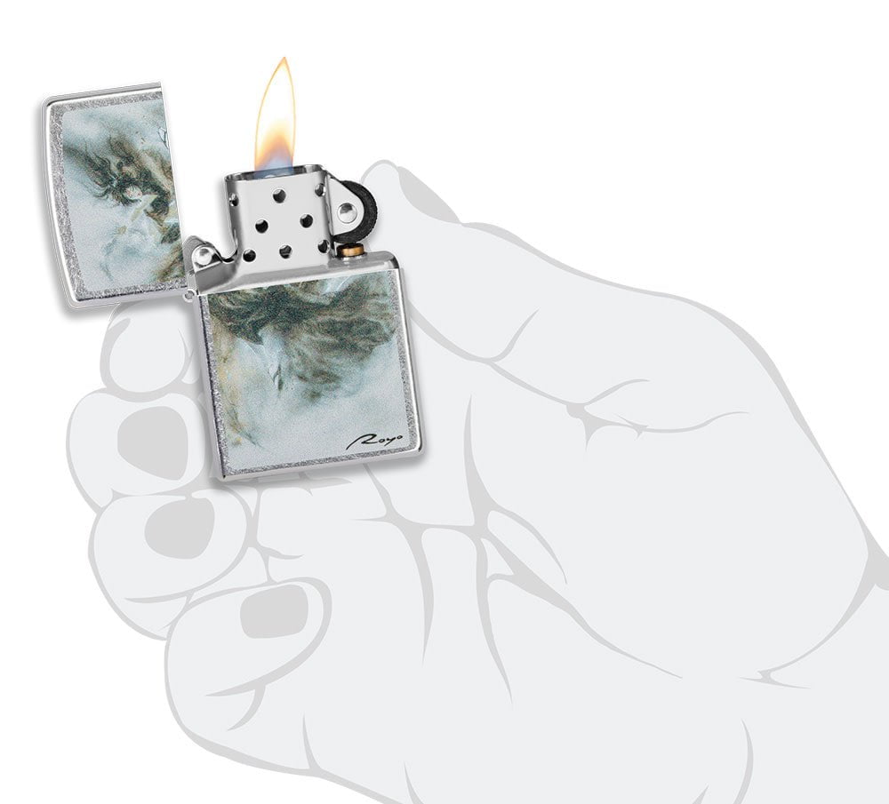 Luis Royo Design Street Chromeâ„¢ Windproof Lighter lit in hand.