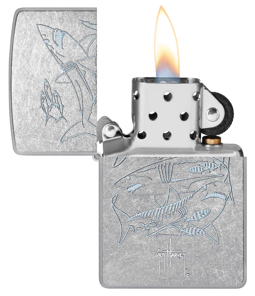 Zippo Guy Harvey Shark Design Street Chomre Windproof Lighter with its lid open and lit.