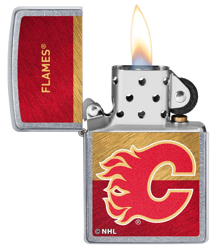 NHL® Calgary Flames Street Chrome™ Windproof Lighter with its lid open and lit