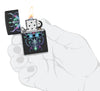 Zippo Cyber Skull Design Black Matte Windproof Lighter lit in hand.