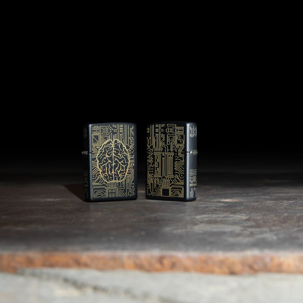 Lifestyle image of two Artificial Intelligence Black Matte Windproof Lighter standing on a stone slab, with one lighter showing the front of the design, and the other showing the back
