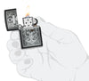 Skull Anchor Emblem Design Black Matte Windproof Lighter lit in hand.