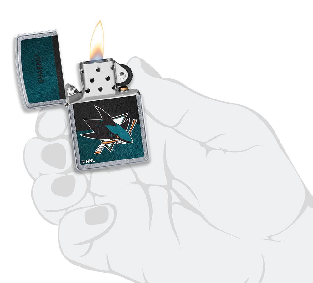 NHL® San Jose Sharks Street Chrome™ Windproof Lighter lit in hand