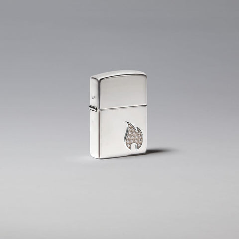 Lifestyle image of Armor® Sterling Silver Flame Emblem Windproof Lighter standing in a silver scene.