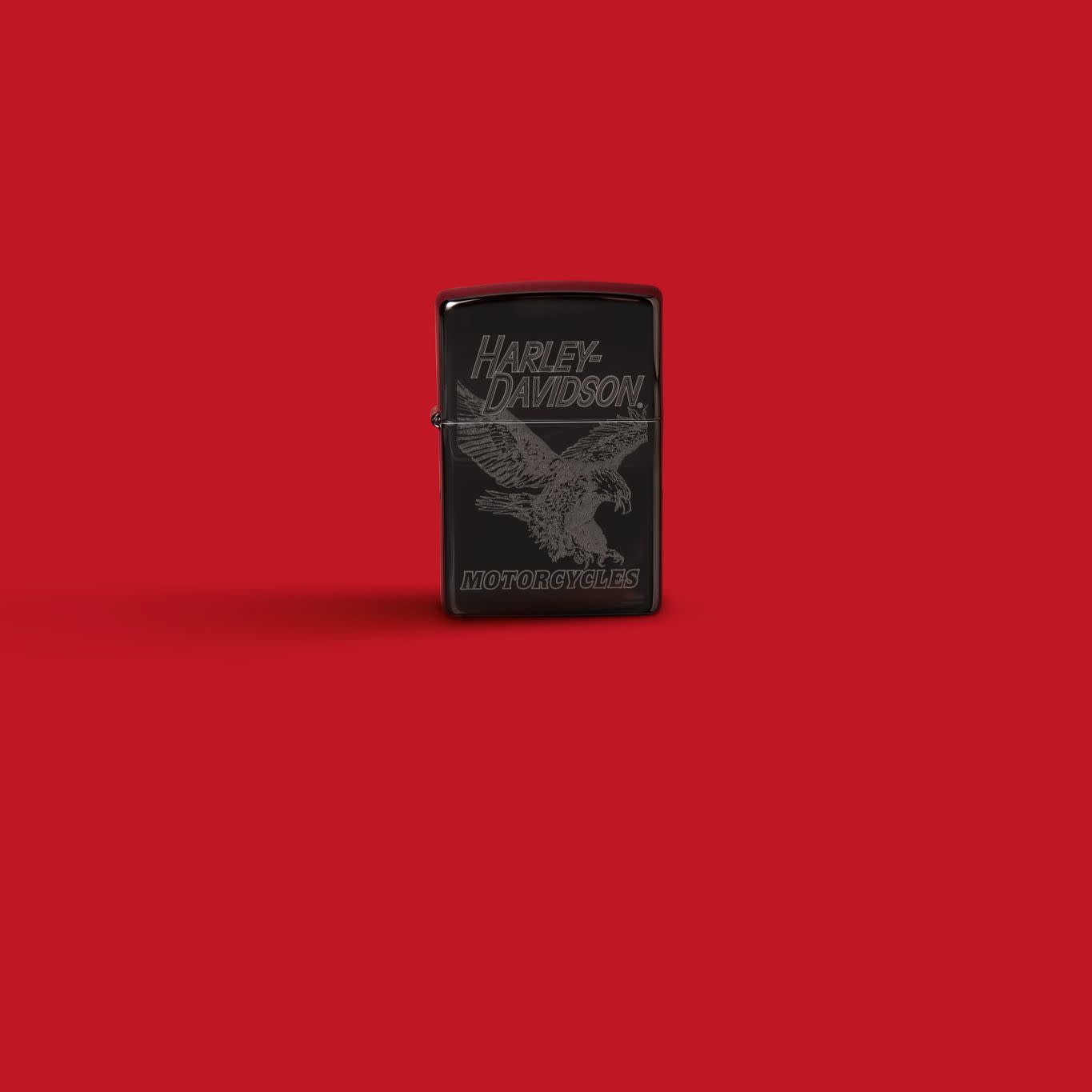 Glamour shot of Zippo Harley-Davidson Laser Fancy Fill High Polish Black Windproof Lighter standing in a red scene.