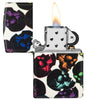 Skulls Design 540 Color Glow in the Dark Windproof Lighter with its lid open and lit.