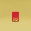 Lifestyle image of Zippo KISS Design Red Matte Windproof Lighter standing in a yellow scene.