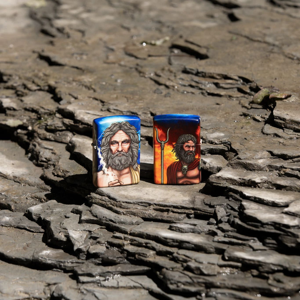 Lifestyle image of two Greek God Clash Design Glow in the Dark 540 Color Windproof Lighters standing on a rock.