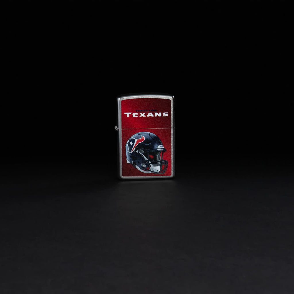 Lifestyle image of NFL Houston Texans Helmet Street Chrome Windproof Lighter standing in a black background.