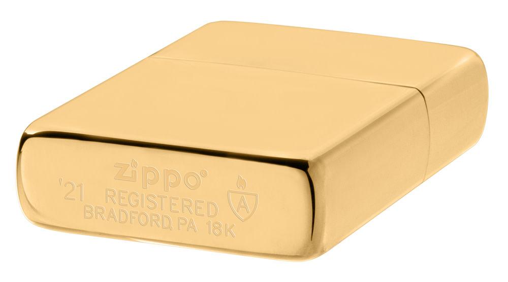 ArmorÂ® High Polish 18K Solid Gold Windproof Lighter laying down at an angle, showing the genuine bottom stamp.