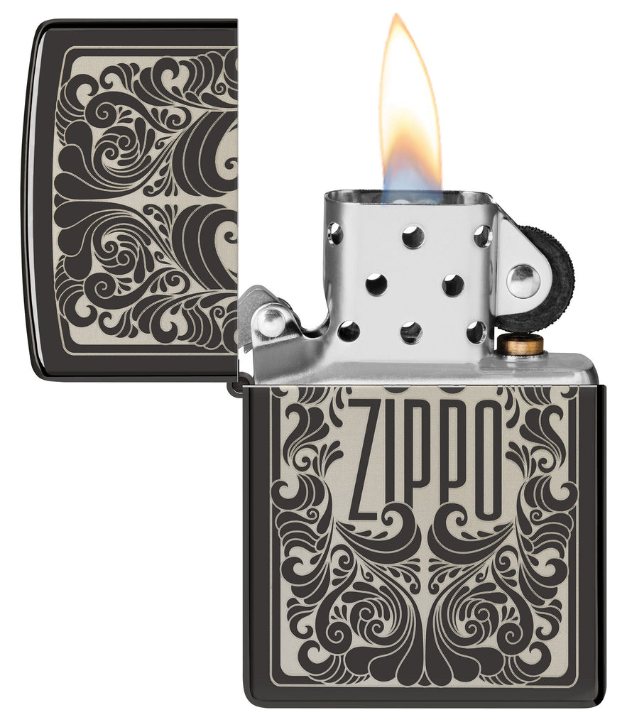 Zippo Logo Filigree Design High Polish Black Windproof Lighter with its lid open and lit.