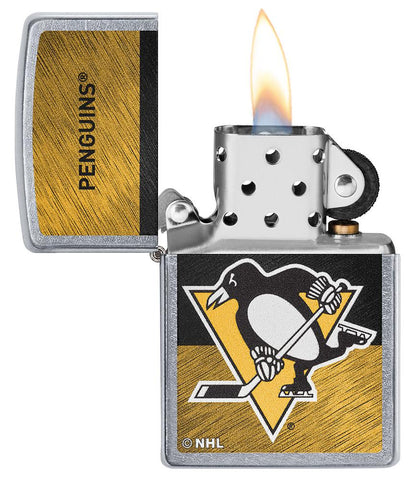 NHL® Pittsburgh Penguins Street Chrome™ Windproof Lighter with its lid open and lit
