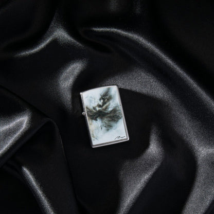Lifestyle image of Luis Royo Design Street Chromeâ„¢ Windproof Lighter laying on a black cloth.