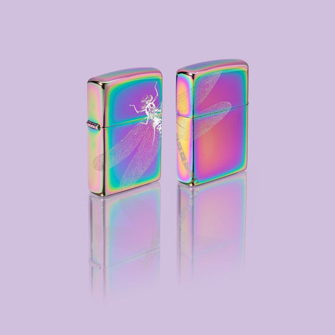 Glamour shot of two Zippo Dragonfly Design Multi Color Windproof Lighters standing in a purple scene.