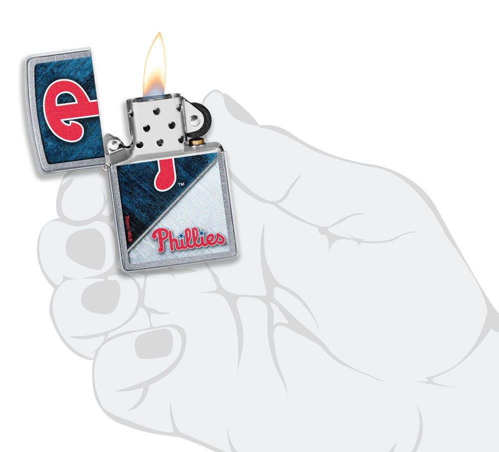 MLB™ Philadelphia Phillies™ Street Chrome™ Windproof Lighter lit in hand.
