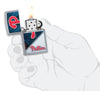 MLB® Philadelphia Phillies™ Street Chrome™ Windproof Lighter lit in hand.