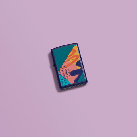 Lifestyle image of Retro Pattern Design Navy Matte Windproof Lighter laying on a purple background.