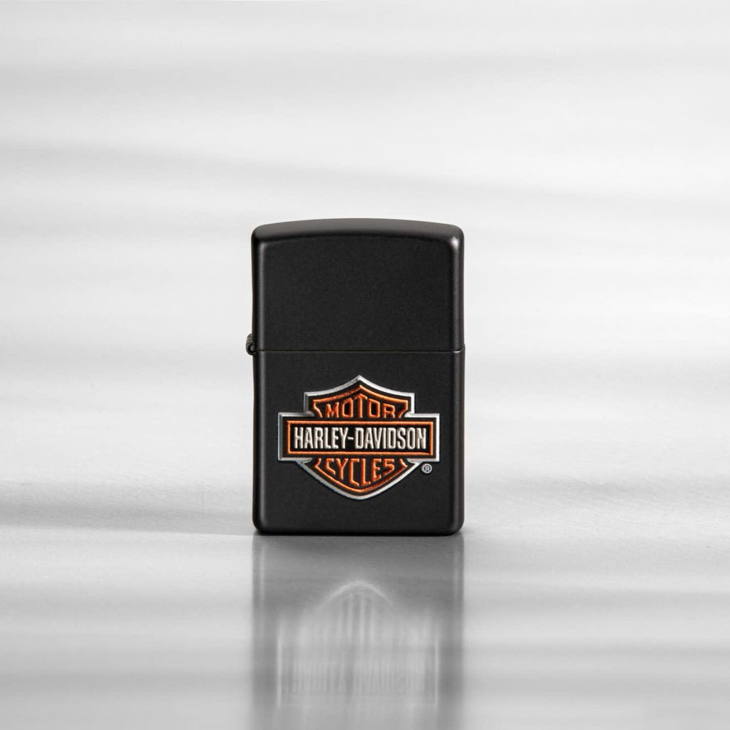 Lifestyle image of Harley-Davidson® Texture Print Classic Logo Black Matte Lighter, standing on a sheet of metal