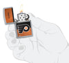 NHL® Philadelphia Flyers Street Chrome™ Windproof Lighter lit in hand