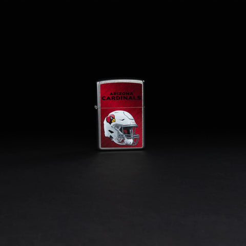 Lifestyle image of NFL Arizona Cardinals Helmet Street Chrome Windproof Lighter on a black background.