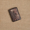 Lifestyle images of Wood Mandala Design Brown Windproof Lighter laying on hemp fabric