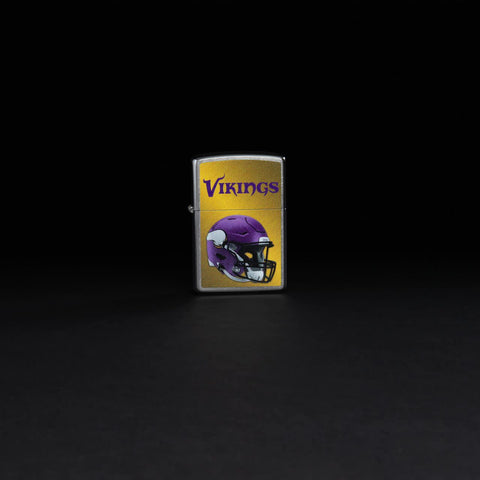 Lifestyle image of NFL Minnesota Vikings Helmet Street Chrome Windproof Lighter standing in a black background.