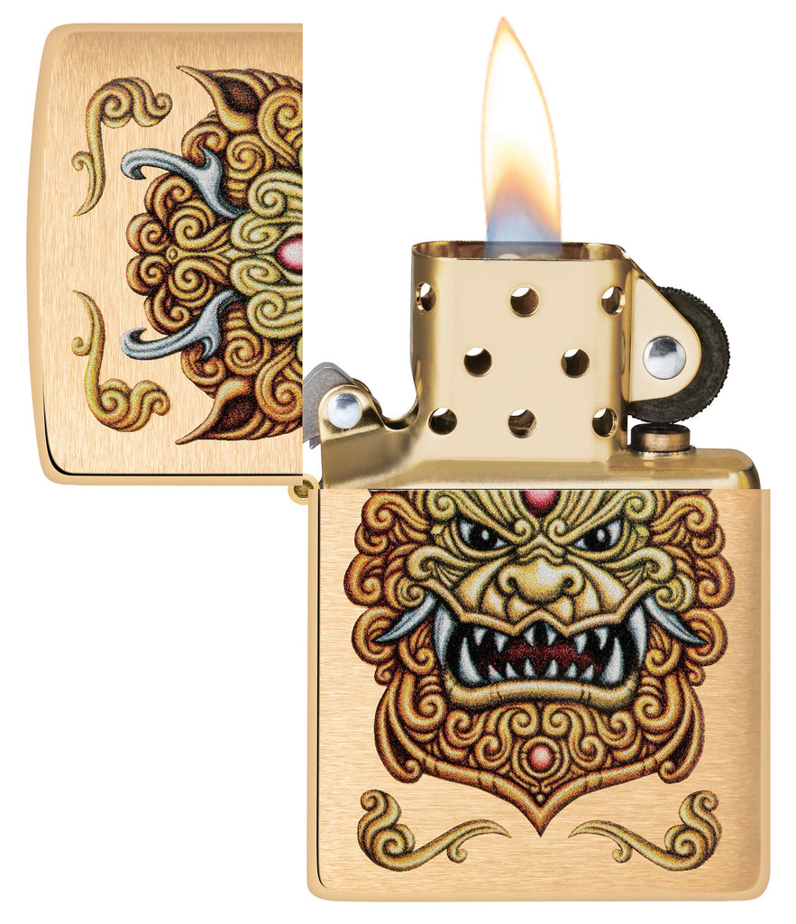 Zippo Foo Dog Design Brushed Brass Windproof Lighter with its lid open and lit.
