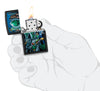 Zippo Alien Attack Design Black Matte Pocket Lighter lit in hand.