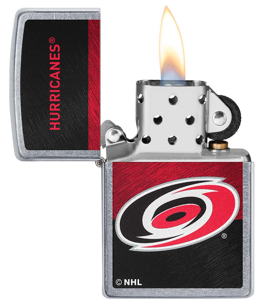 NHL® Carolina Hurricanes Street Chrome™ Windproof Lighter with its lid open and lit