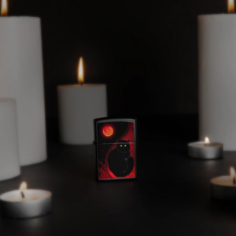 Lifestyle image of Black Cat Design Black Matte Windproof Lighter standing with lit candles.