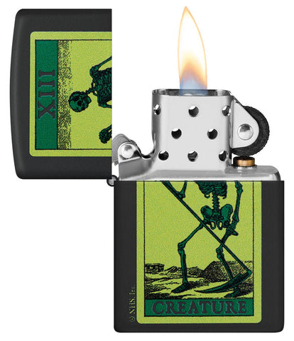 Creature Skeleton Black Matte Windproof Lighter with its lid open and lit.