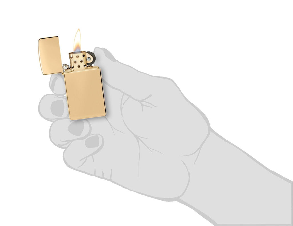 Slim® High Polish Brass Finish Windproof Lighter lit in hand.