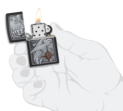 Zippo Ship Shark Emblem Design Black Matte Windproof Lighter lit in hand.