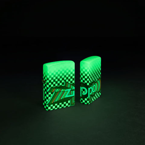 Glamour Shot of two Zippo Nostalgia Design 540 Color Glow in the Dark Windproof Lighters glowing in the dark.