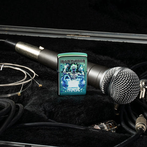 Lifestyle image of Iron Maiden Eddie Design High Polish Teal Windproof Lighter standing with cords and a microphone.
