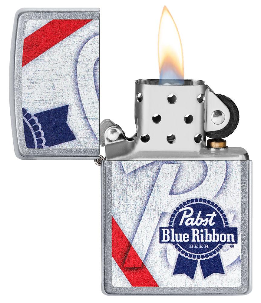 Pabst Blue Ribbon Street Chrome™ Windproof Lighter with its lid open and lit