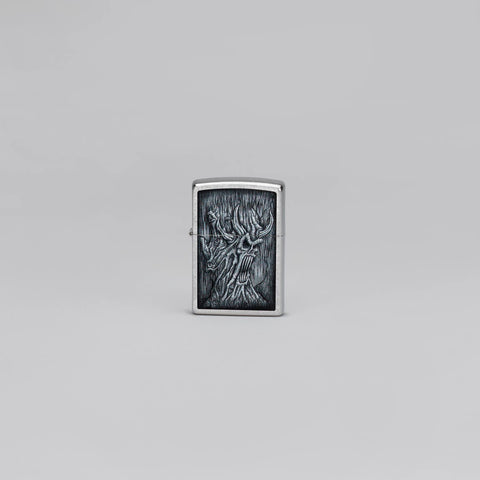 Lifestyle image of Zippo Evil Tree Design Street Chrome Windproof Lighter standing in a grey scene.