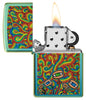Psychedelic Imagery Design High Polish Teal Windproof Lighter with its lid open and lit.