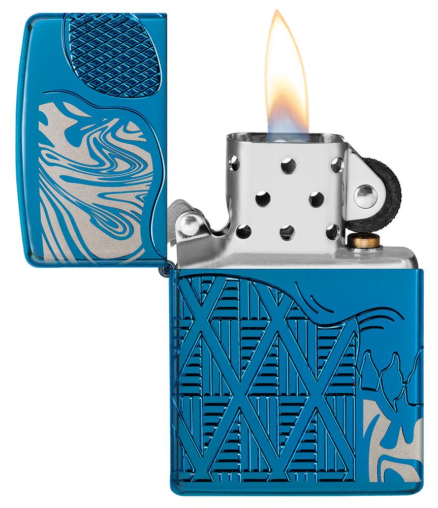 Skull Design Armor® High Polish Blue Windproof Lighter with its lid open and lit.